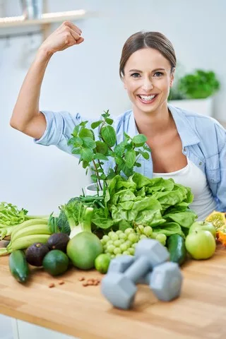 healthy adult woman with green food in the kitchen 2026 03 17 07 15 35 utc 1